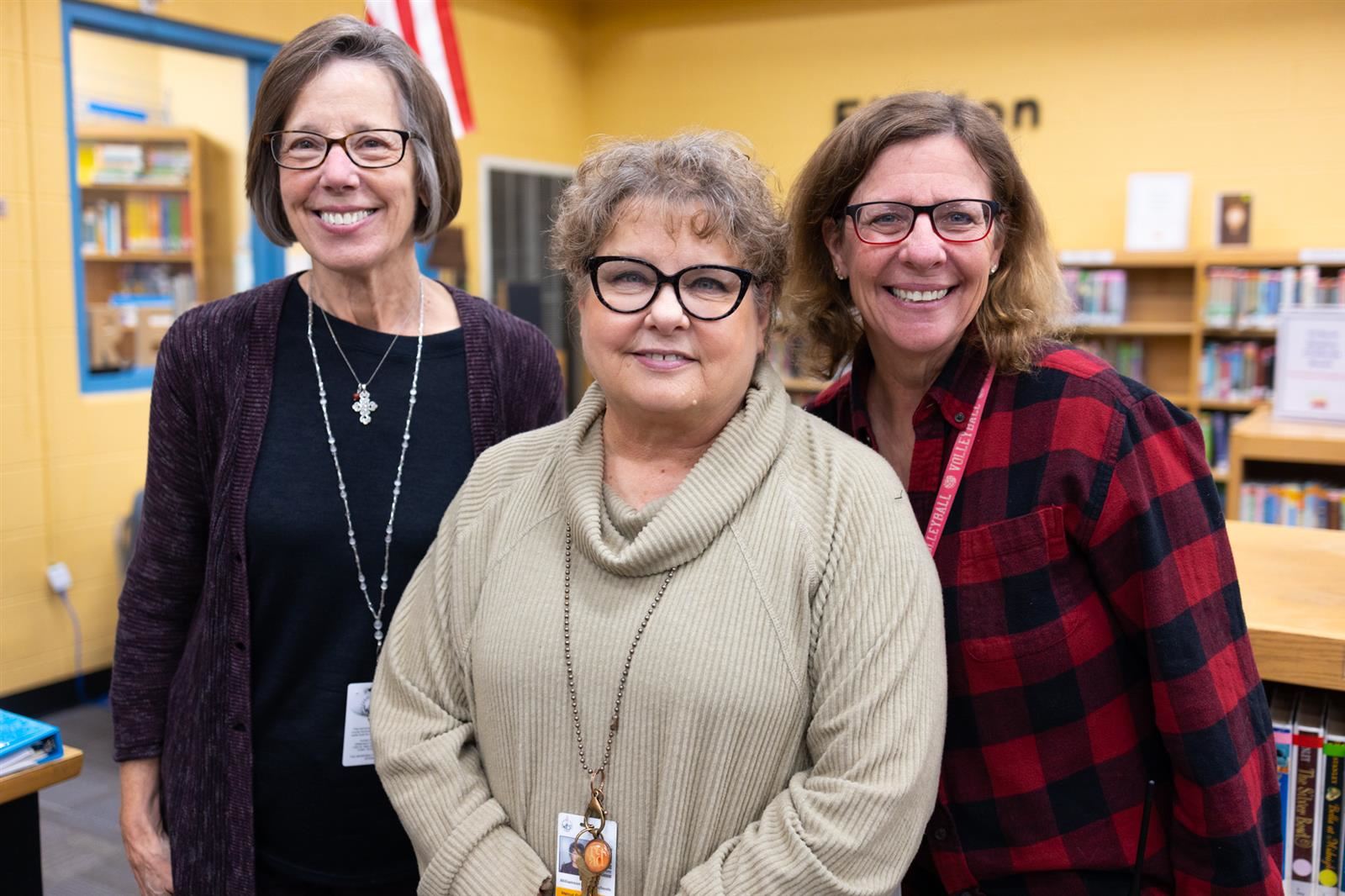 Three library teachers inside the library
